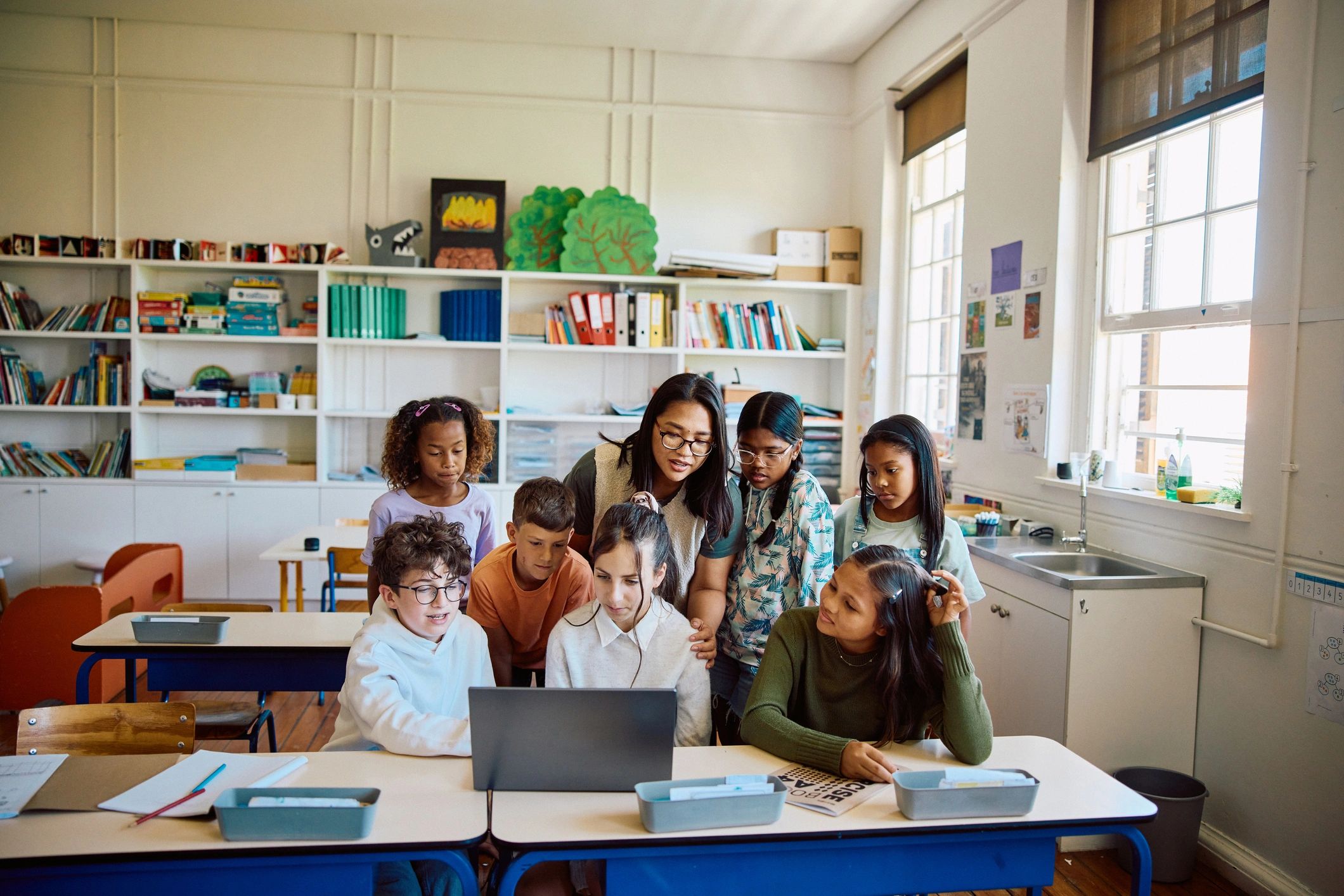Group gathered around a laptop during a collaborative session